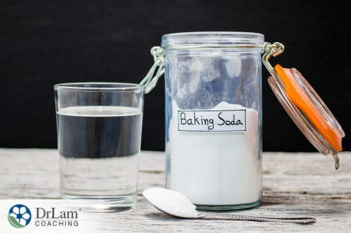 An image of a glass of water and a container of baking soda